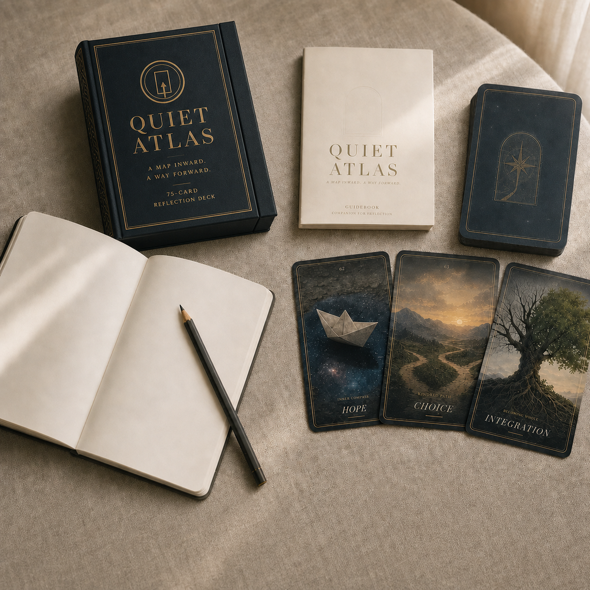 Quiet Atlas magnetic reflection deck box, guidebook and illustrated cards beside a journal